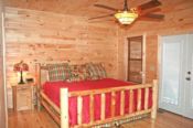Log bed in the master bedroom with private whirlpool tub